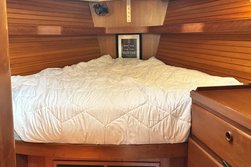 Slide: The Image of Cozy cabin interior of 1999 Sabre 452 yacht with wooden paneling and comfortable bedding. - 42
