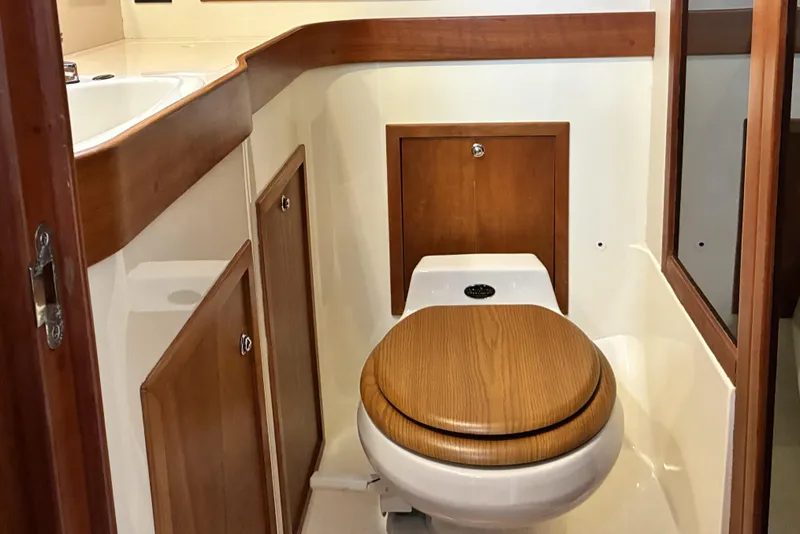 Slide: The Image of 1999 Sabre 452 yacht bathroom with wooden cabinetry and toilet. - 36