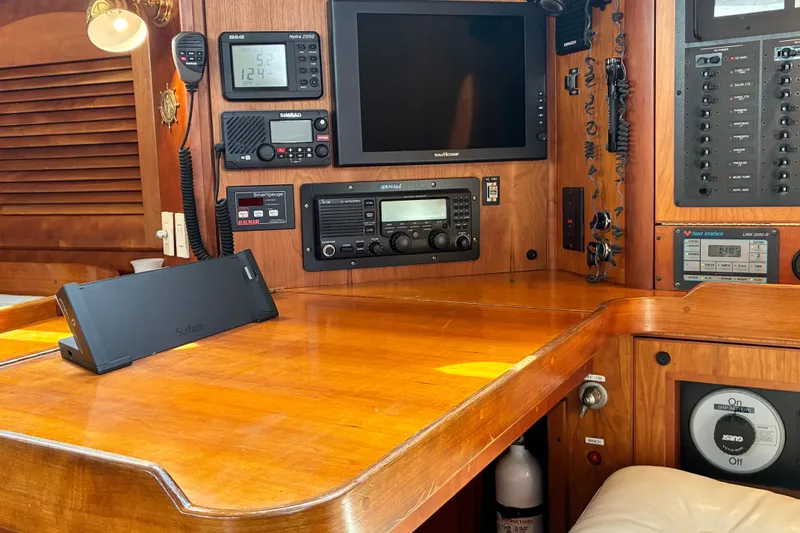 Slide: The Image of Navigation station on a 1999 Sabre 452 yacht with electronic equipment and wooden finish. - 33