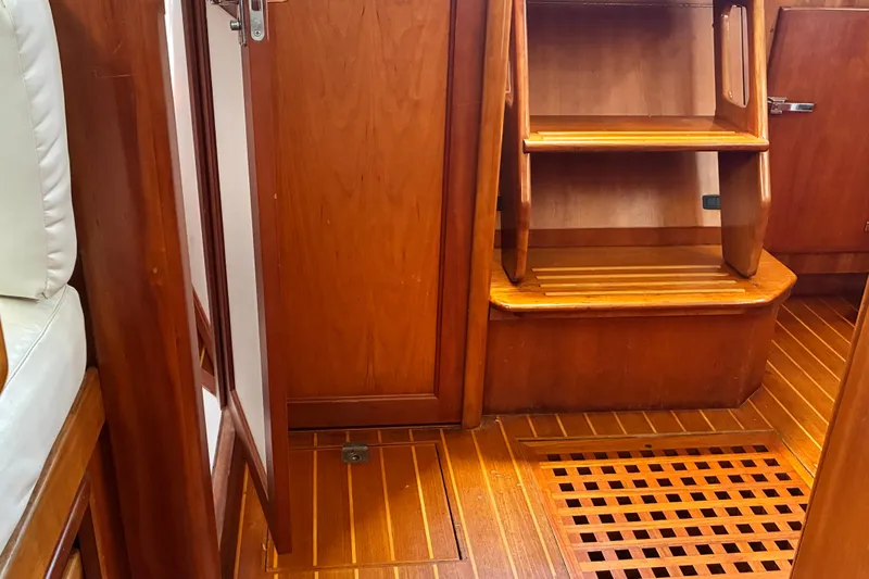 Slide: The Image of Interior of a 1999 Sabre 452 yacht featuring wooden stairs and flooring. - 18