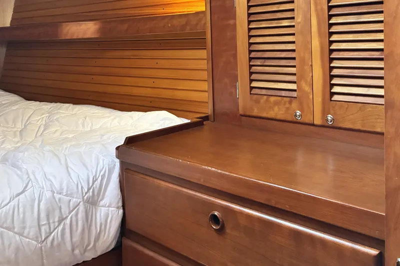 Slide: The Image of Wooden interior of a 1999 Sabre 452 yacht with bed and storage cabinet. - 43