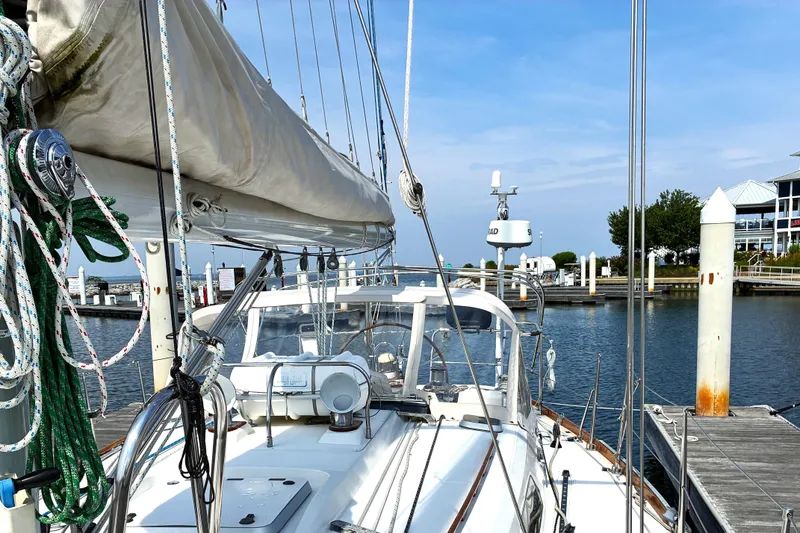 Slide: The Image of Sailboat docked at marina, Sabre 452 model from 1999, with clear blue sky. - 12