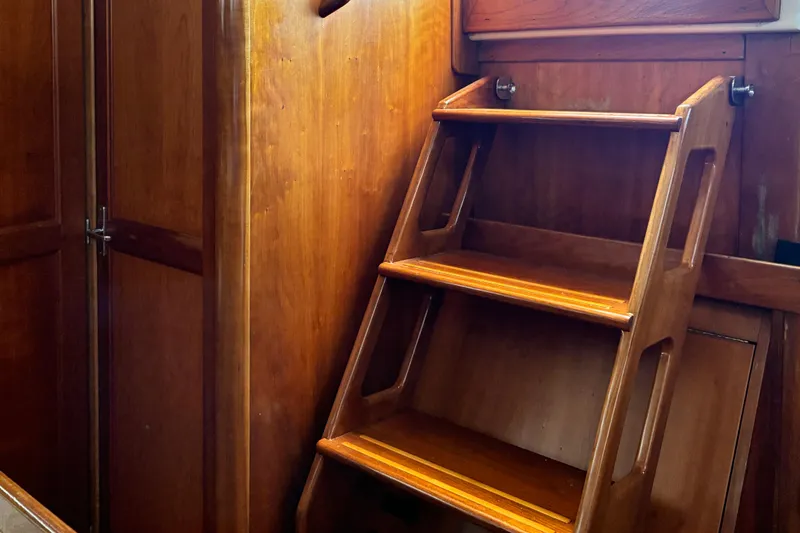 Slide: The Image of Wooden interior stairs on a 1999 Sabre 452 yacht, showcasing elegant craftsmanship. - 17