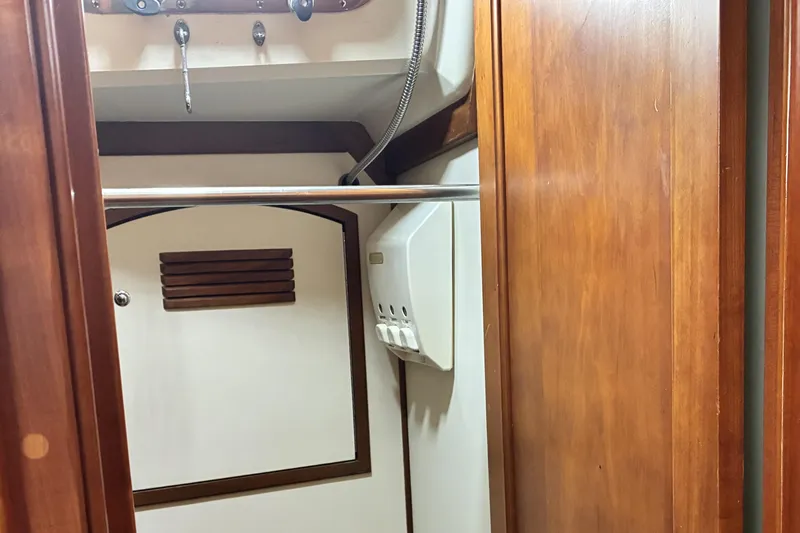 Slide: The Image of Wooden interior of a 1999 Sabre 452 yacht, featuring storage and paneling. - 40
