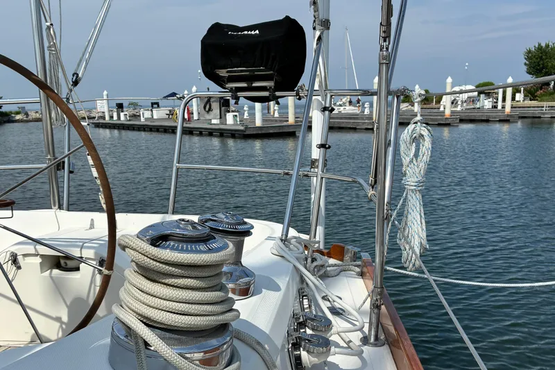 Slide: The Image of Sailboat deck view with ropes and winches, dock in background, Sabre 452, 1999 model. - 8