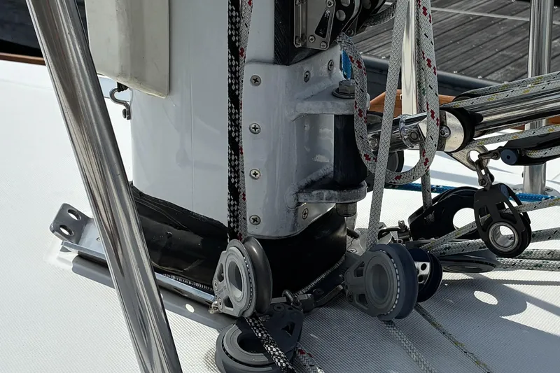 Slide: The Image of Close-up of sailing rigging on a 1999 Sabre 452 yacht, featuring ropes and pulleys. - 14