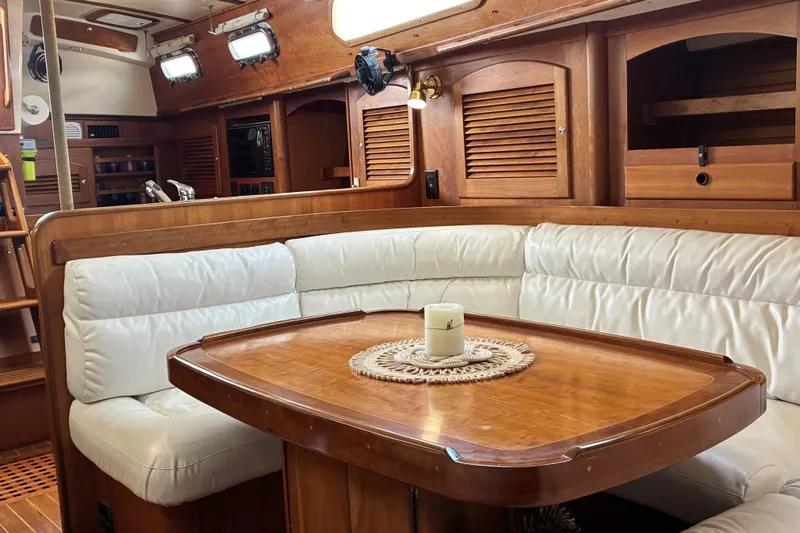 Slide: The Image of Luxurious interior of 1999 Sabre 452 yacht with white leather seating and wooden table. - 28