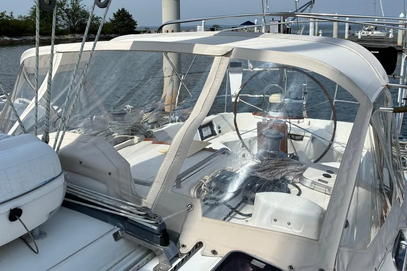 Slide: The Image of Sailboat cockpit of a 1999 Sabre 452 with protective canopy, docked at a marina. - 11
