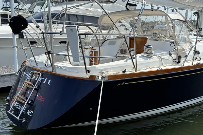 Slide: The Image of 1999 Sabre 452 sailboat docked, featuring sleek design and polished wood accents. - 3