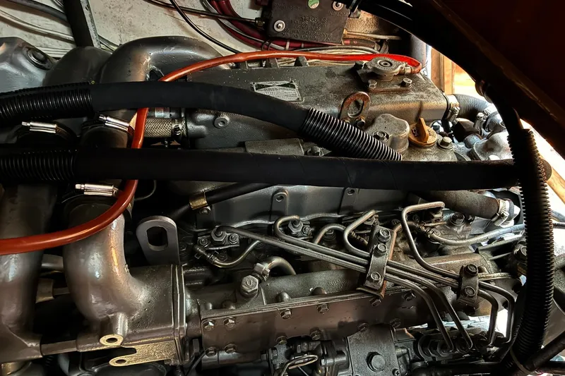 Slide: The Image of Engine of a 1999 Sabre 452, showcasing intricate mechanical components and hoses. - 49