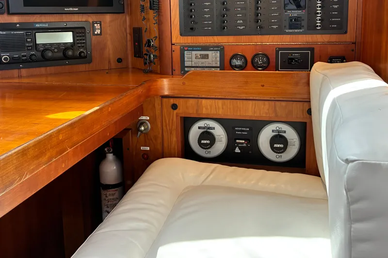 Slide: The Image of 1999 Sabre 452 yacht interior with control panel and cushioned seating. - 31