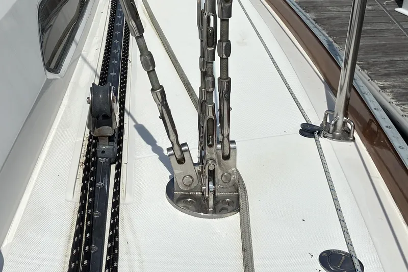 Slide: The Image of Deck rigging of a 1999 Sabre 452 sailboat, featuring stainless steel fittings and tracks. - 13