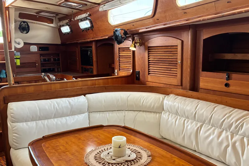 Slide: The Image of Luxurious 1999 Sabre 452 yacht interior with wooden cabinetry and white leather seating. - 24