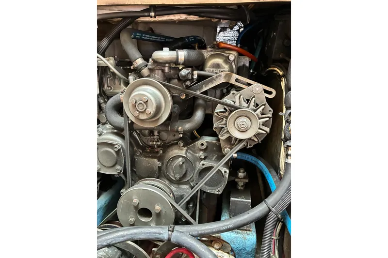 Slide: The Image of Engine of a 1999 Sabre 452, showcasing belts and pulleys in a compact arrangement. - 51