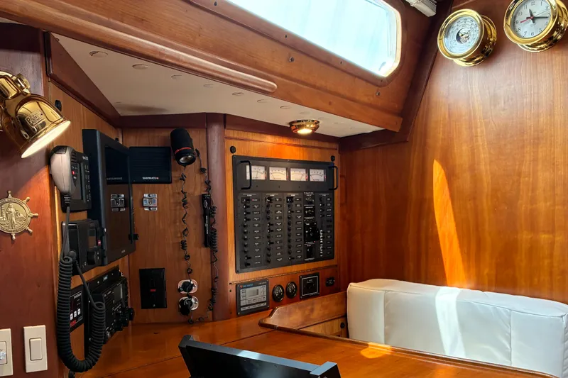 Slide: The Image of Interior of a 1999 Sabre 452 yacht with navigation equipment and wooden paneling. - 30