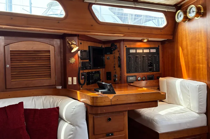 Slide: The Image of Luxurious 1999 Sabre 452 yacht interior with wooden navigation station and plush seating. - 29