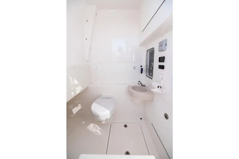 Slide: The Image of Interior of 2022 Invincible 39 Open Fisherman boat bathroom, featuring toilet and sink. - 33