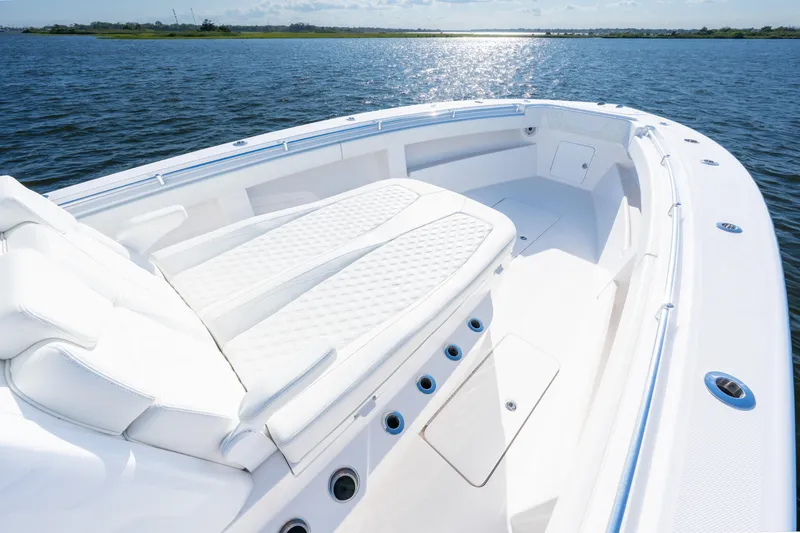 Slide: The Image of 2022 Invincible 39 Open Fisherman boat with spacious deck and luxurious seating on calm water. - 9