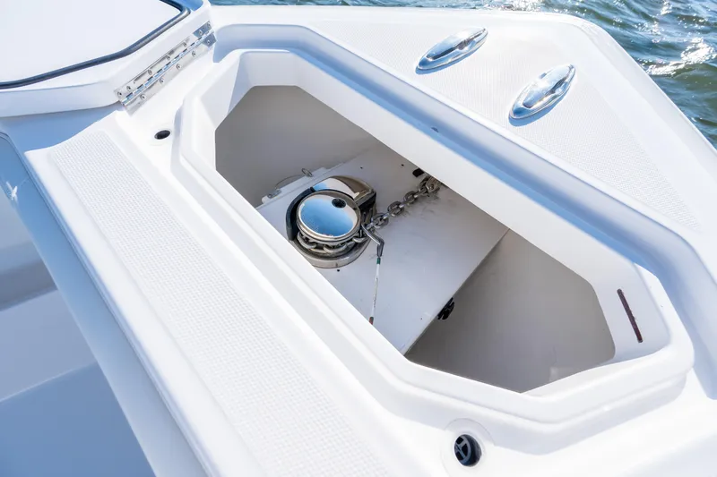 Slide: The Image of Anchor compartment of 2022 Invincible 39 Open Fisherman boat, featuring sleek design and storage. - 8