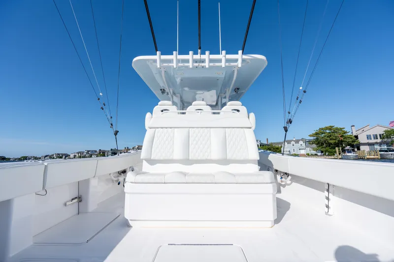 Slide: The Image of 2022 Invincible 39 Open Fisherman boat with sleek white seating and clear blue sky backdrop. - 29