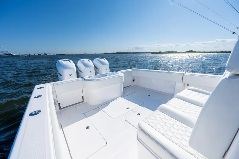 Slide: The Image of 2022 Invincible 39 Open Fisherman boat with triple engines on a sunny day. - 24