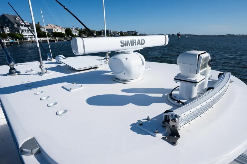 Slide: The Image of 2022 Invincible 39 Open Fisherman boat with Simrad radar on deck, near waterfront homes. - 14