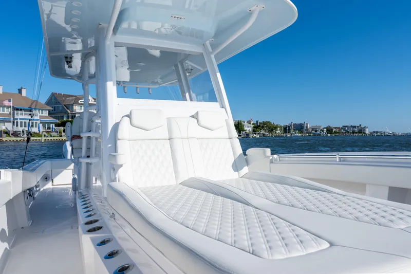 Slide: The Image of 2022 Invincible 39 Open Fisherman boat with luxurious white seating, dockside view. - 11