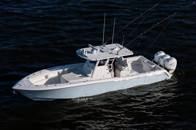 Slide: The Image of 2022 Invincible 39 Open Fisherman boat on dark water, featuring triple outboard engines. - 6