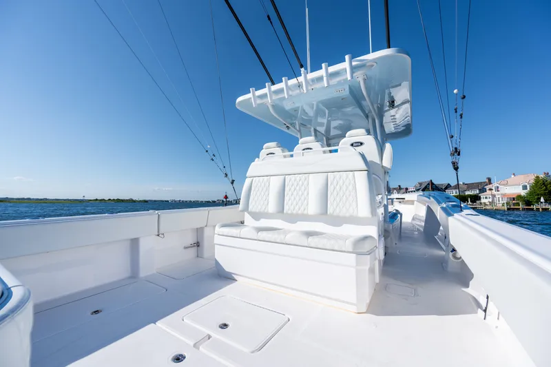 Slide: The Image of 2022 Invincible 39 Open Fisherman boat with sleek white seating and clear blue sky. - 26
