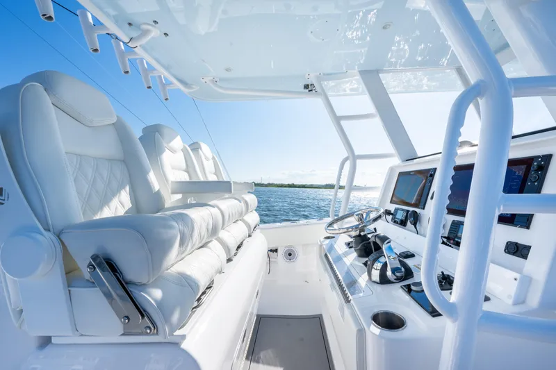 Slide: The Image of 2022 Invincible 39 Open Fisherman boat interior with luxurious seating and advanced navigation controls. - 20