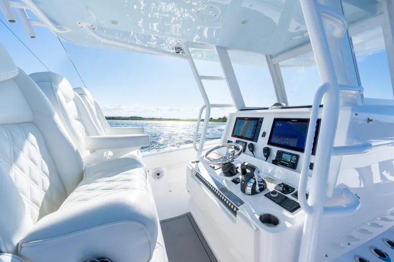 Slide: The Image of 2022 Invincible 39 Open Fisherman boat cockpit with modern controls and luxurious seating. - 21