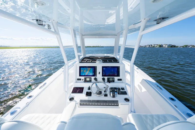 Slide: The Image of 2022 Invincible 39 Open Fisherman boat dashboard with navigation screens on open water. - 15