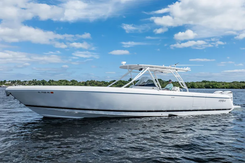 Slide: The Image of 2011 Intrepid 400 Center Console boat on calm water under blue sky. - 2