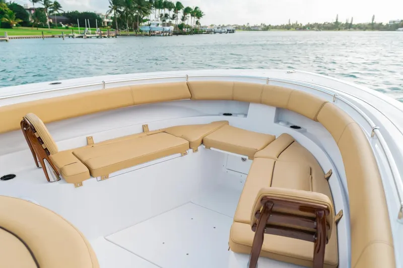 Slide: The Image of 2026 Sportsman Open 352 Center Console boat with tan seating, docked on calm water. - 2