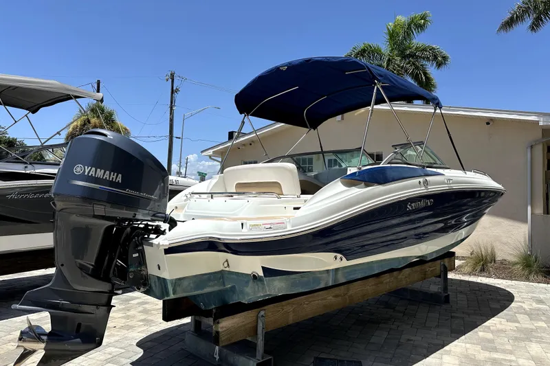Slide: The Image of 2014 SouthWind 2400 SD boat with Yamaha engine, parked outdoors under clear blue sky. - 3