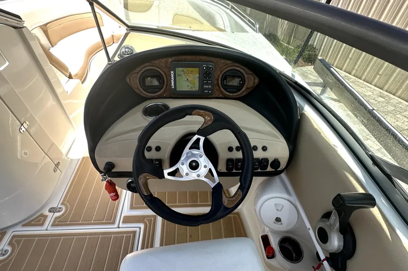 Slide: The Image of 2014 SouthWind 2400 SD boat dashboard with steering wheel and navigation system. - 9