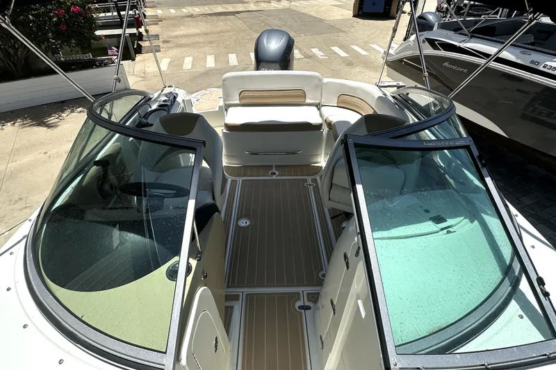 Slide: The Image of 2014 SouthWind 2400 SD boat interior with seating and windshield, docked at marina. - 6