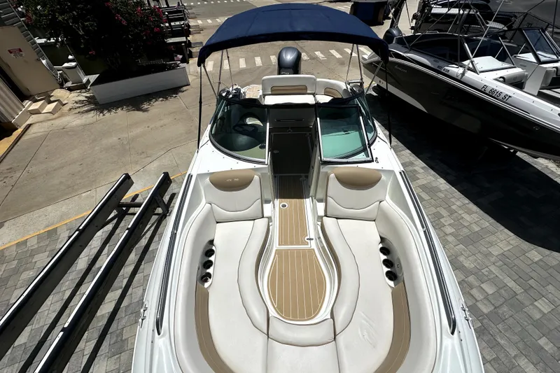 Slide: The Image of 2014 SouthWind 2400 SD boat with spacious seating and canopy, docked at a marina. - 5
