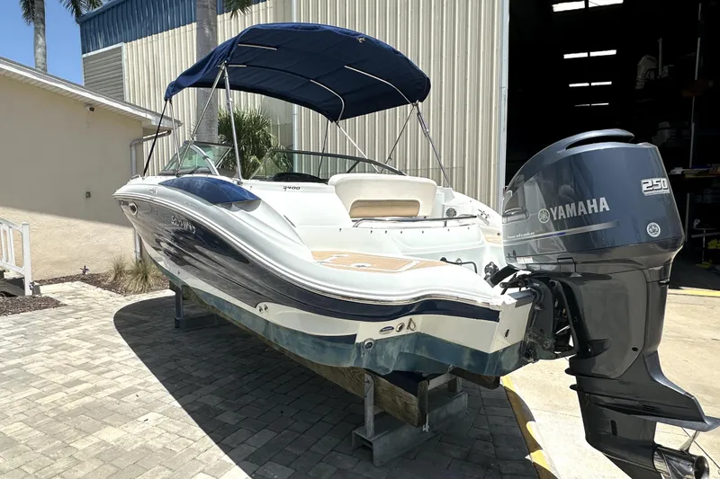 Slide: The Image of 2014 SouthWind 2400 SD boat with Yamaha 250 engine, parked outdoors. - 2
