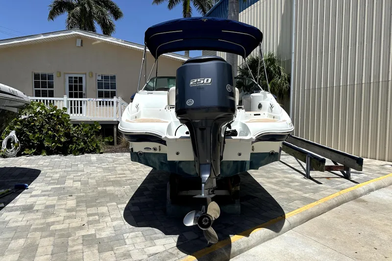 Slide: The Image of 2014 SouthWind 2400 SD boat with Yamaha 250 engine, parked on a paved driveway. - 4
