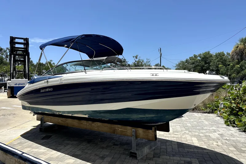 The Image of 2014 SouthWind 2400 SD boat with blue canopy on a sunny day. - 0