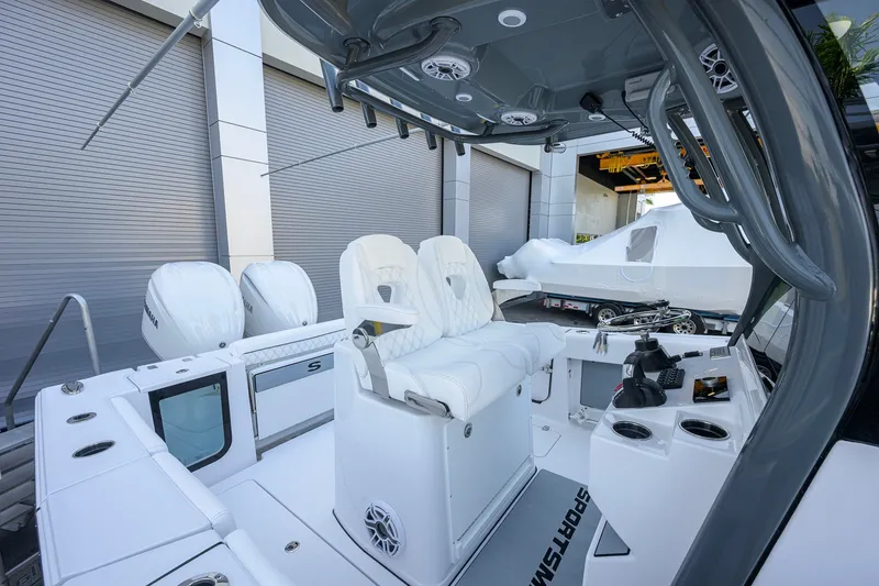 Slide: The Image of 2027 Sportsman Open 262 Center Console boat interior with dual engines and modern seating. - 20