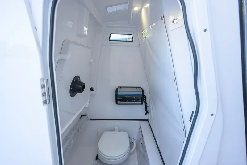 Slide: The Image of Interior of 2027 Sportsman Open 262 Center Console boat's compact bathroom. - 46