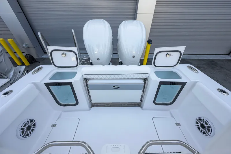 Slide: The Image of 2027 Sportsman Open 262 Center Console boat with dual engines and storage compartments. - 29
