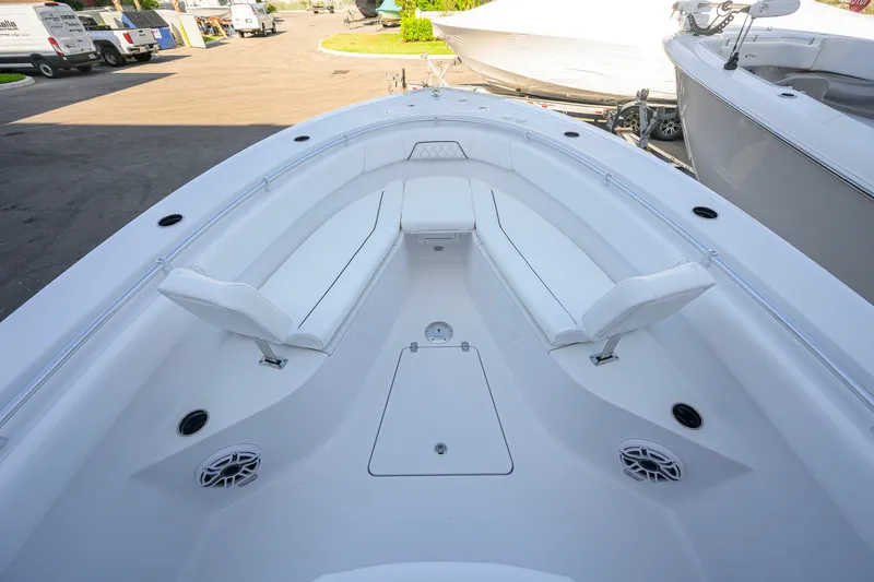 Slide: The Image of 2027 Sportsman Open 262 Center Console boat interior with white seating and deck layout. - 11