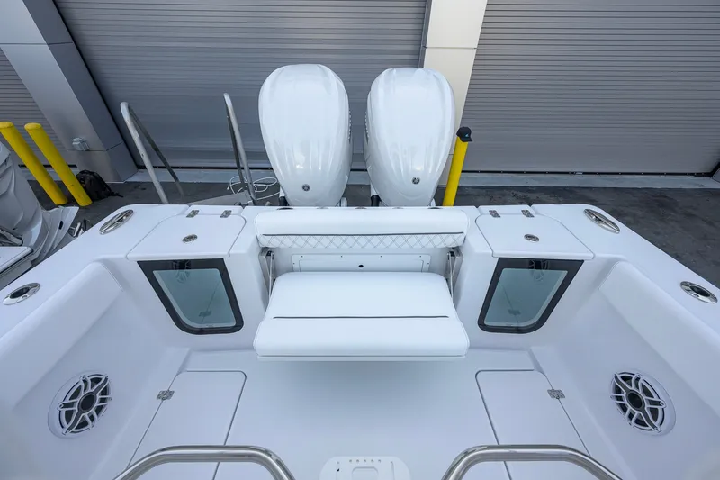 Slide: The Image of 2027 Sportsman Open 262 Center Console boat with dual engines and spacious seating area. - 28