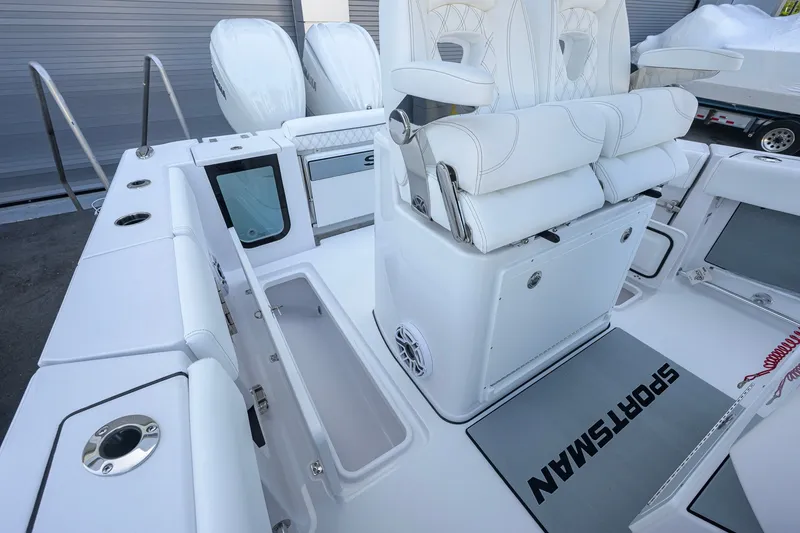 Slide: The Image of 2027 Sportsman Open 262 Center Console boat interior with white seating and storage compartments. - 23