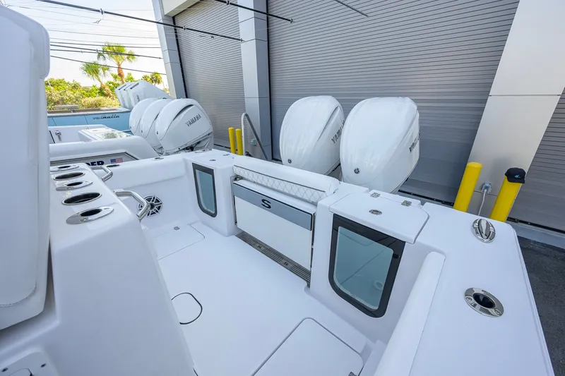 Slide: The Image of 2027 Sportsman Open 262 Center Console boat with twin Yamaha engines, docked outdoors. - 30
