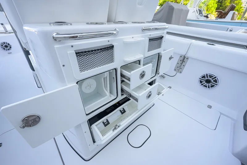 Slide: The Image of 2027 Sportsman Open 262 Center Console boat storage compartments and drawers. - 41