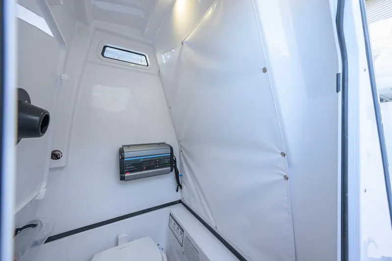 Slide: The Image of Interior of 2027 Sportsman Open 262 Center Console boat, featuring compact cabin space. - 48